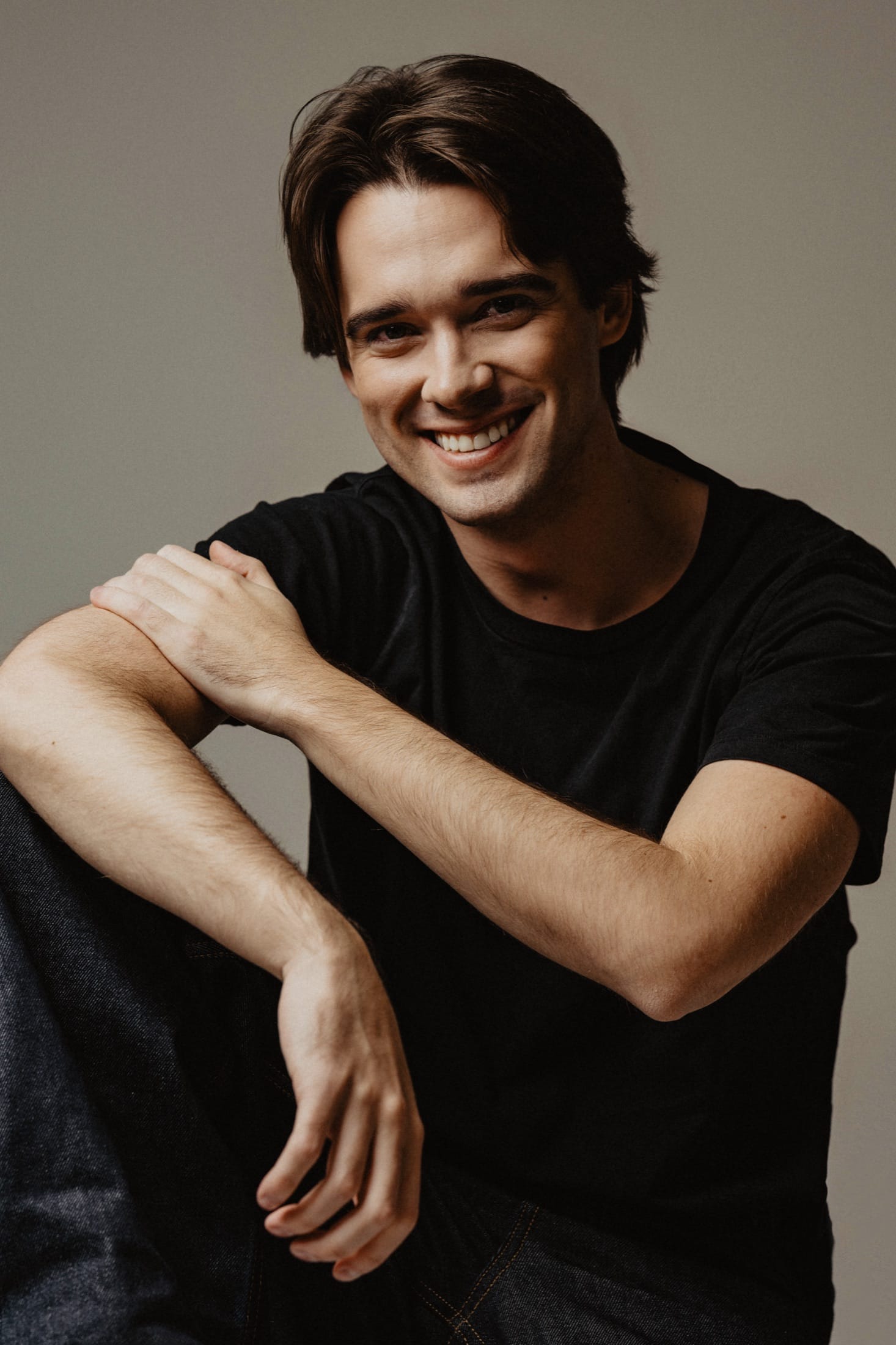 Headshot, smiling, black t-shirt