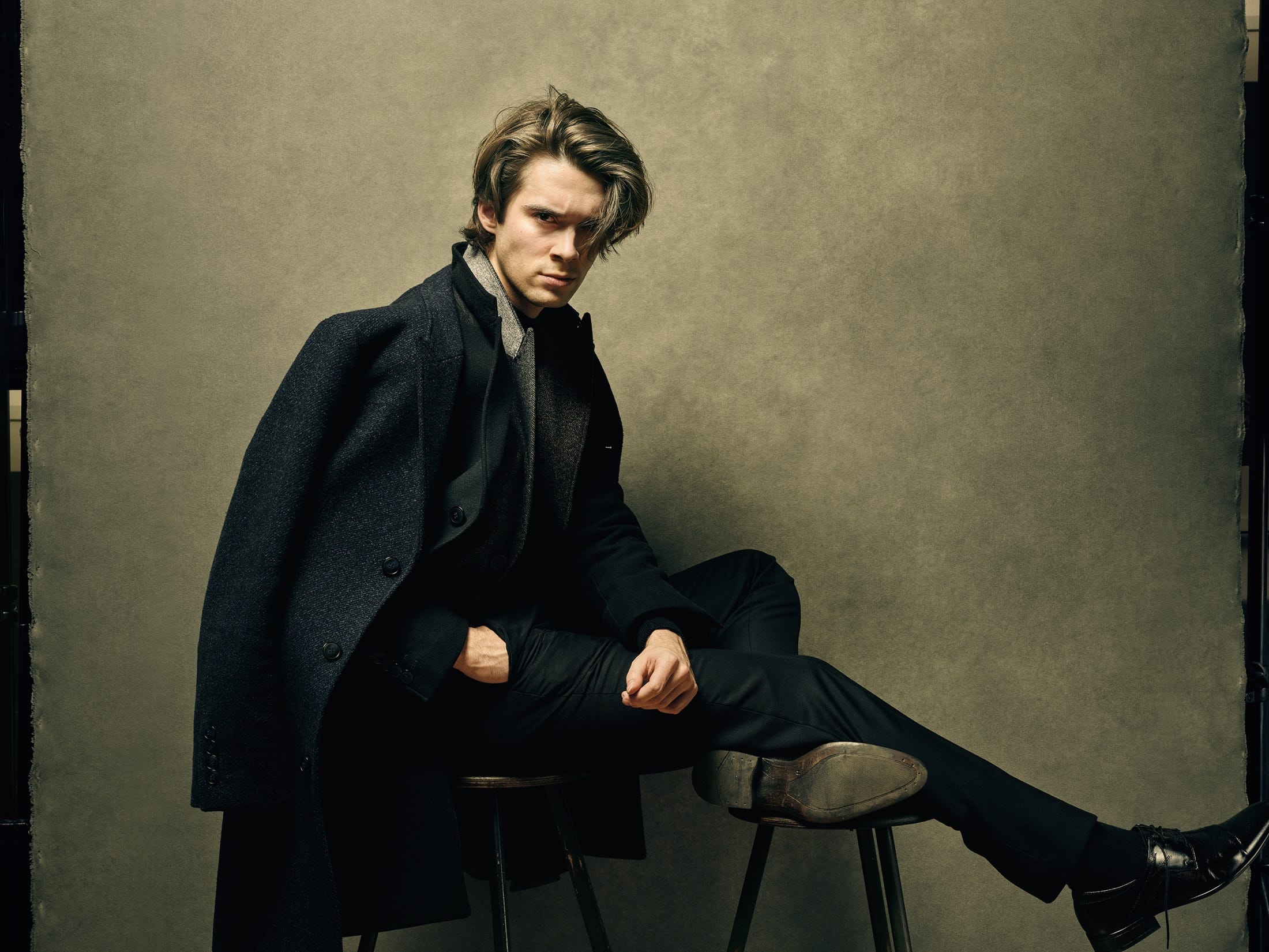 Seated portrait in a coat